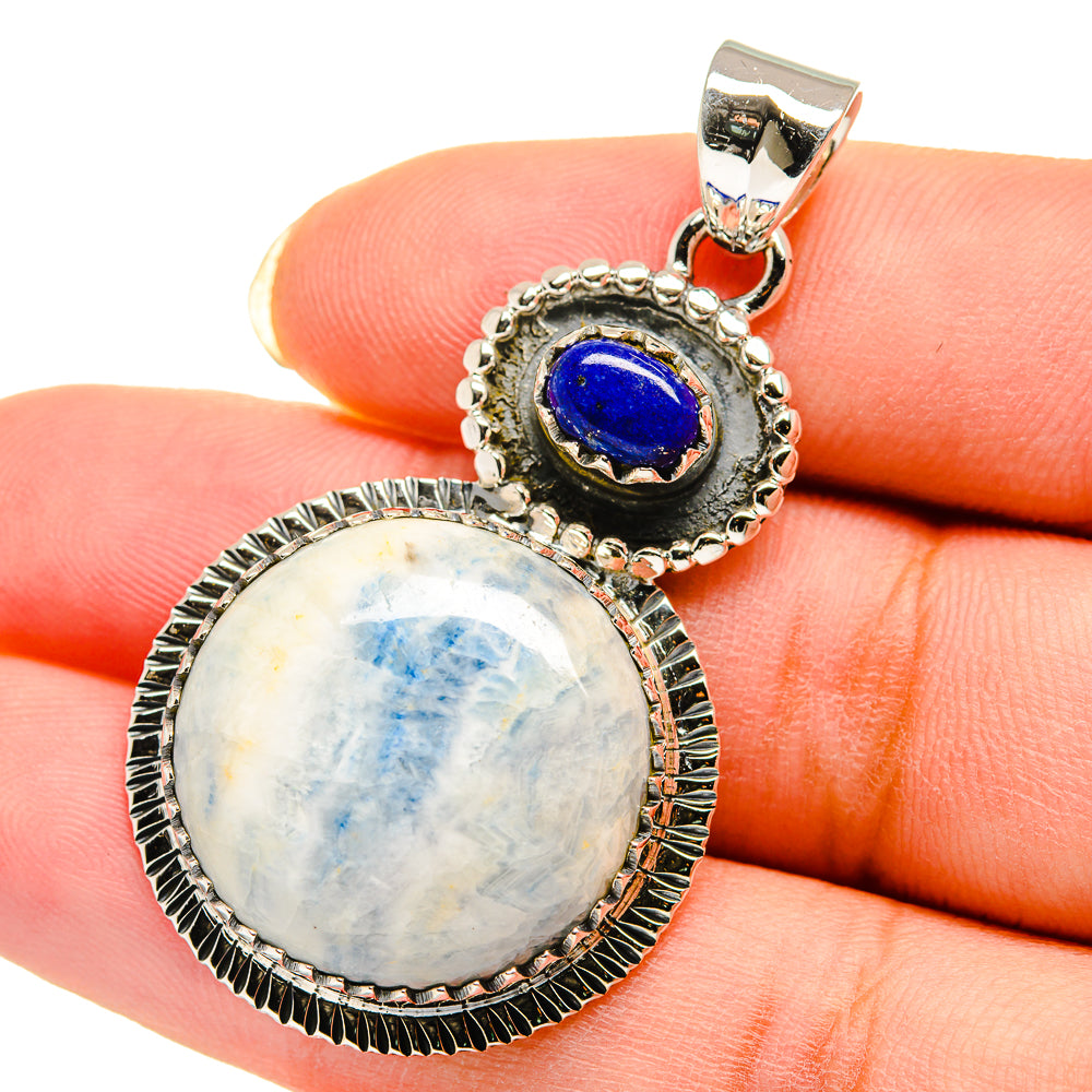 Sterling silver pendant close-up: blue cabochon, opalescent oval stone, rope-edge bezel