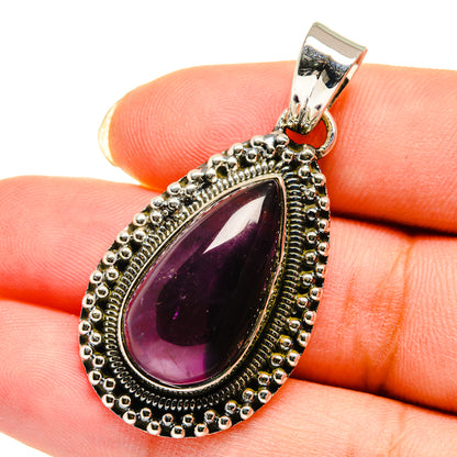Amethyst teardrop pendant detail with dark purple stone and silver beaded frame, top bail