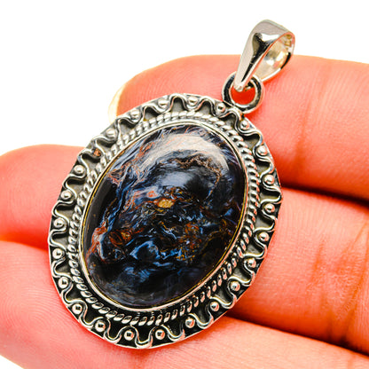 Sterling silver pietersite pendant, oval blue-and-brown cabochon in detailed border with bail