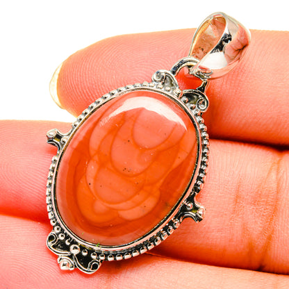 Oval orange imperial jasper sterling silver pendant with ornate frame and loop bail