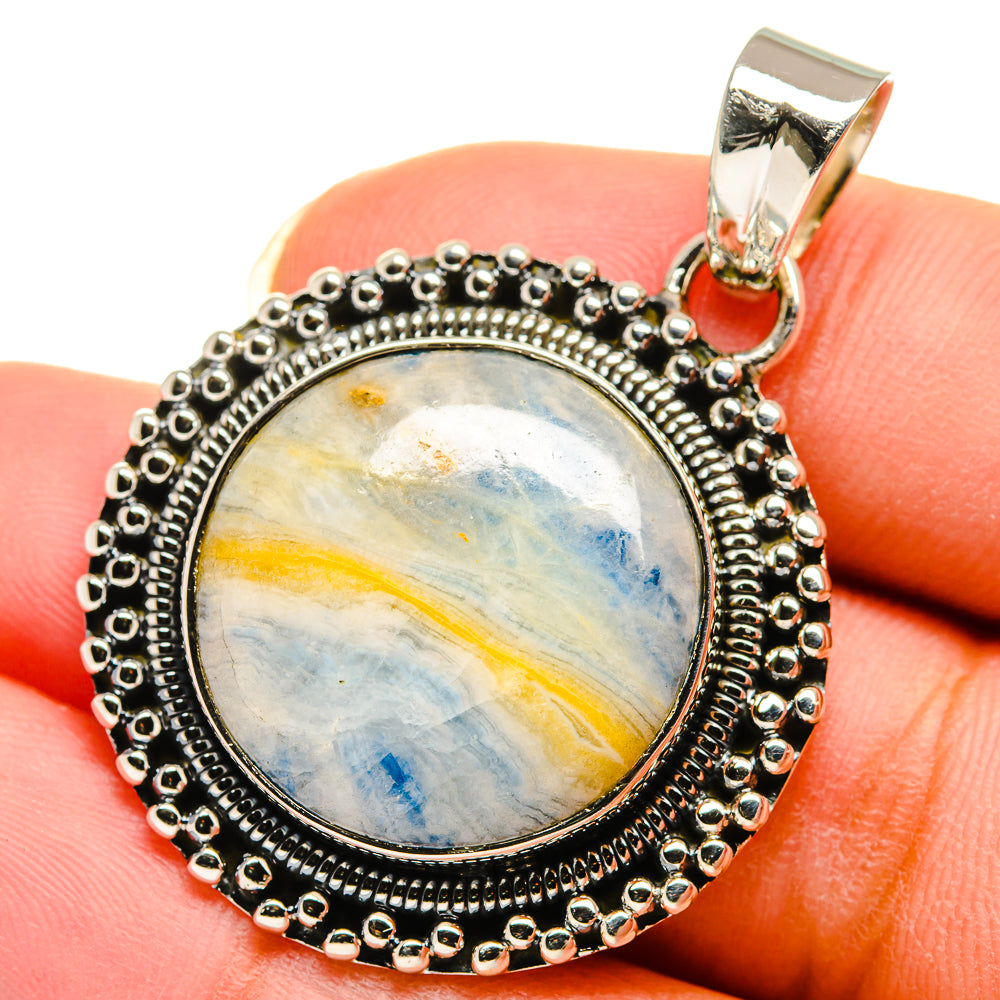 Blue scheelite pendant with oval cabochon, sterling silver bezel and bail on top