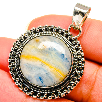 Blue scheelite pendant with oval cabochon, sterling silver bezel and bail on top