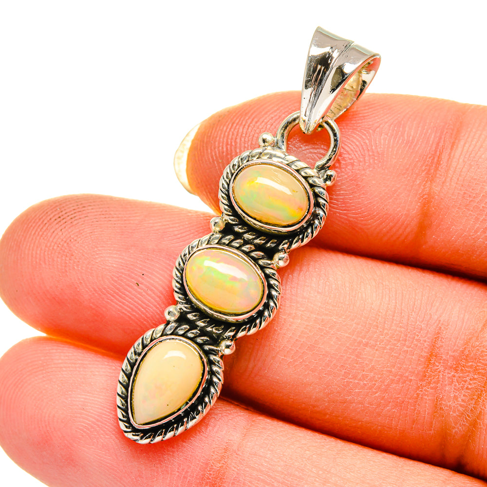 Sterling silver three-opal pendant with yellow iridescent oval cabochons in detailed frames