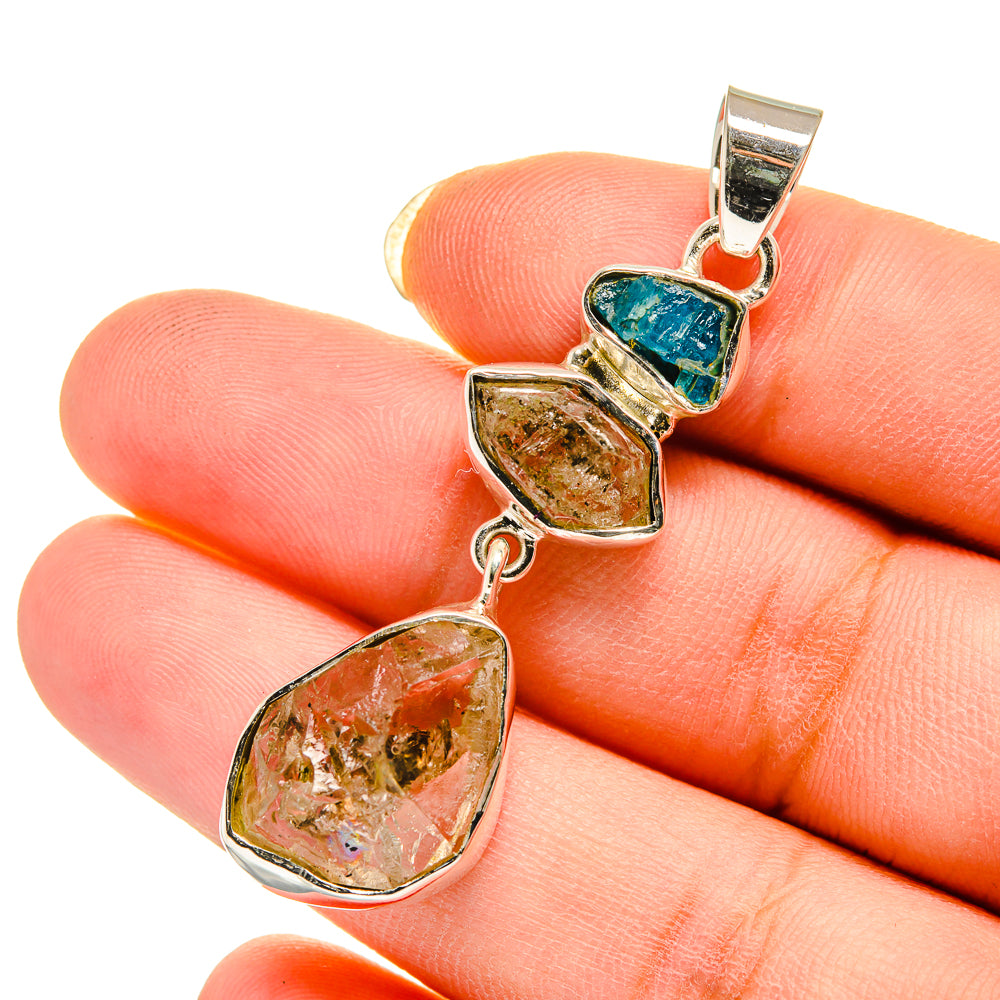 Sterling silver pendant with three gemstone drops: blue, amber, and clear quartz-like