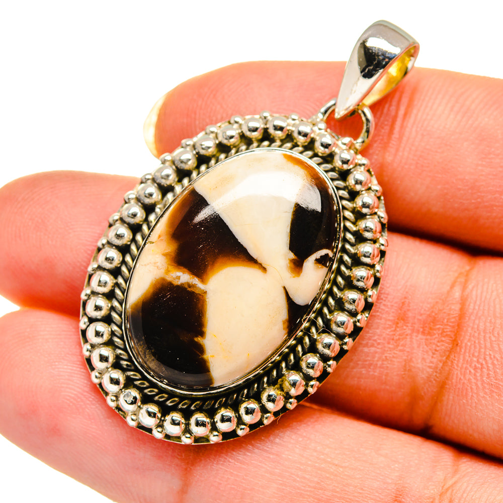 Oval peanut wood jasper pendant close-up with silver-tone beaded border and open bail