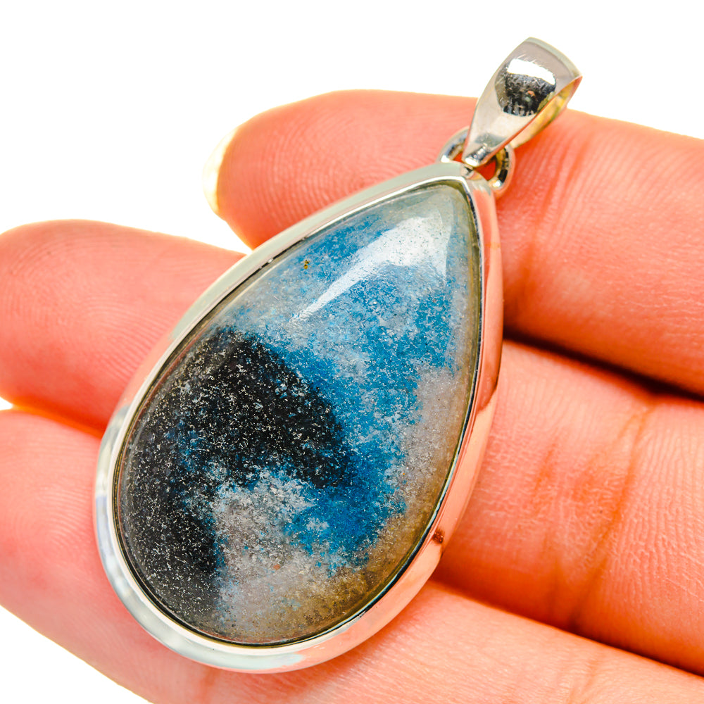 Teardrop apatite pendant with blue-and-black stone in silver bezel on top bail