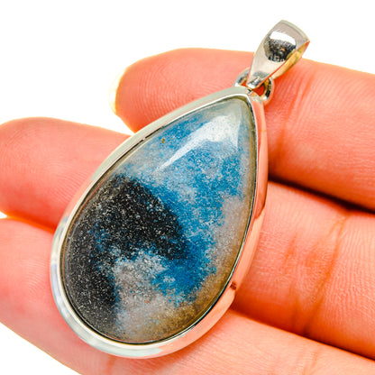 Teardrop apatite pendant with blue-and-black stone in silver bezel on top bail
