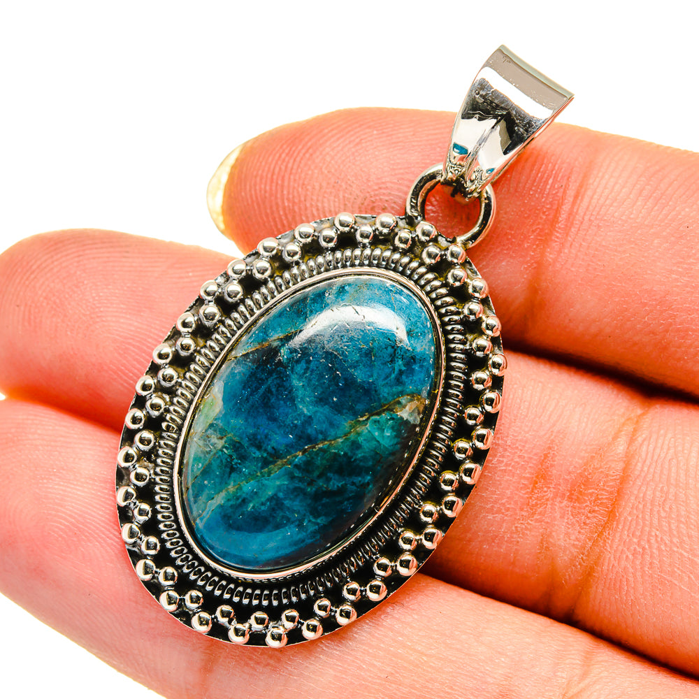 Chrysocolla pendant in oval bezel of silver with bead border, blue stone center