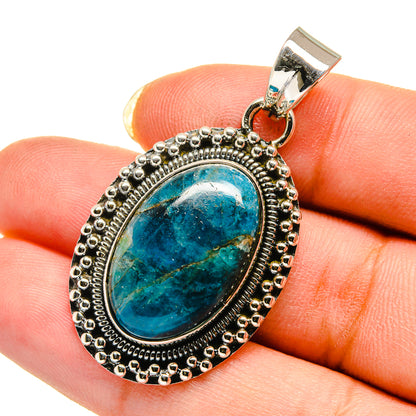 Chrysocolla pendant in oval bezel of silver with bead border, blue stone center