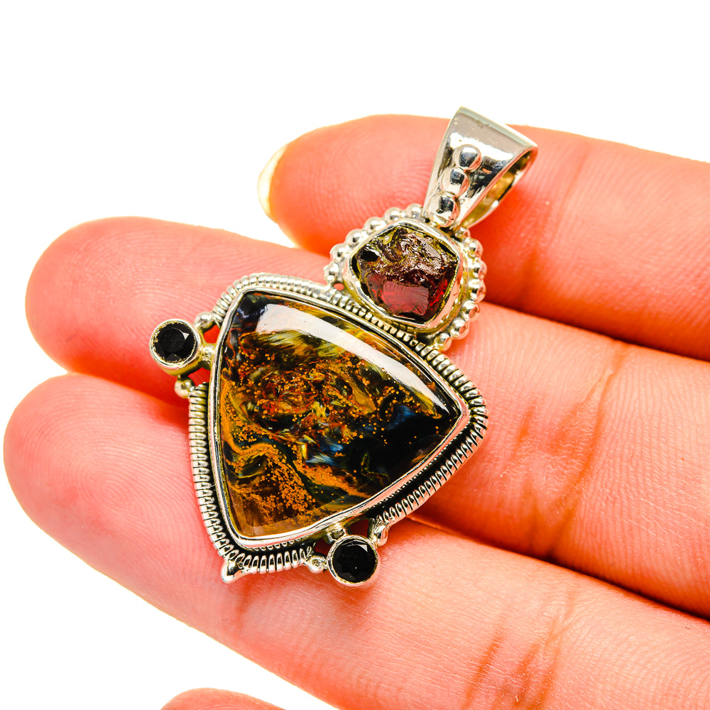 Sterling silver pendant close-up with amber pietersite center and black onyx round stones