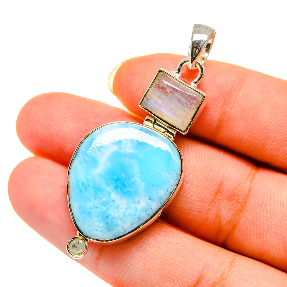 Sterling silver teardrop pendant close-up on blue gemstone with square bail and small charm