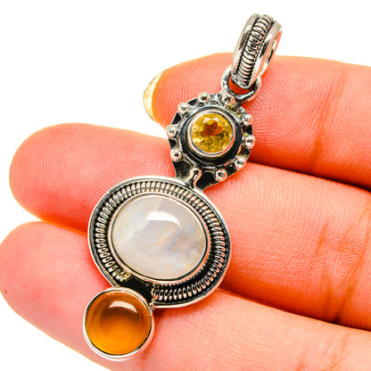 Sterling silver pendant with white and yellow cabochon stones and orange accents