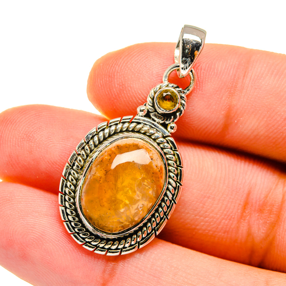 Oval citrine pendant with amber teardrop center stone in sterling silver setting