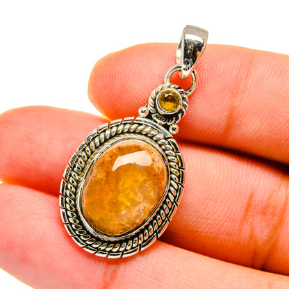 Oval citrine pendant with amber teardrop center stone in sterling silver setting