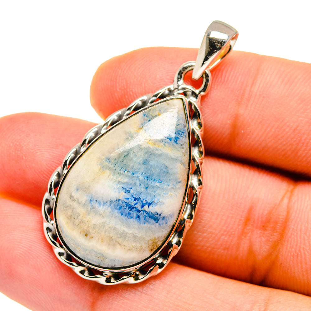 Sterling silver teardrop pendant with blue scheelite in ornate bezel setting