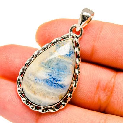 Sterling silver teardrop pendant with blue scheelite in ornate bezel setting