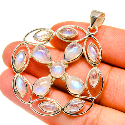 Sterling silver pendant with iridescent opal-like teardrop stones in a halo frame