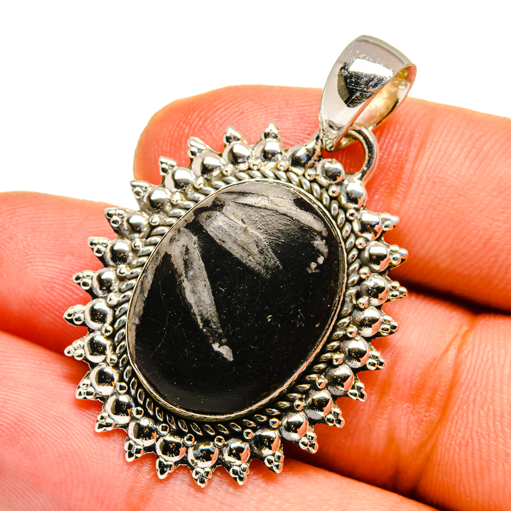 Sterling silver stone pendant with round black cabochon and ornate chrysanthemum border