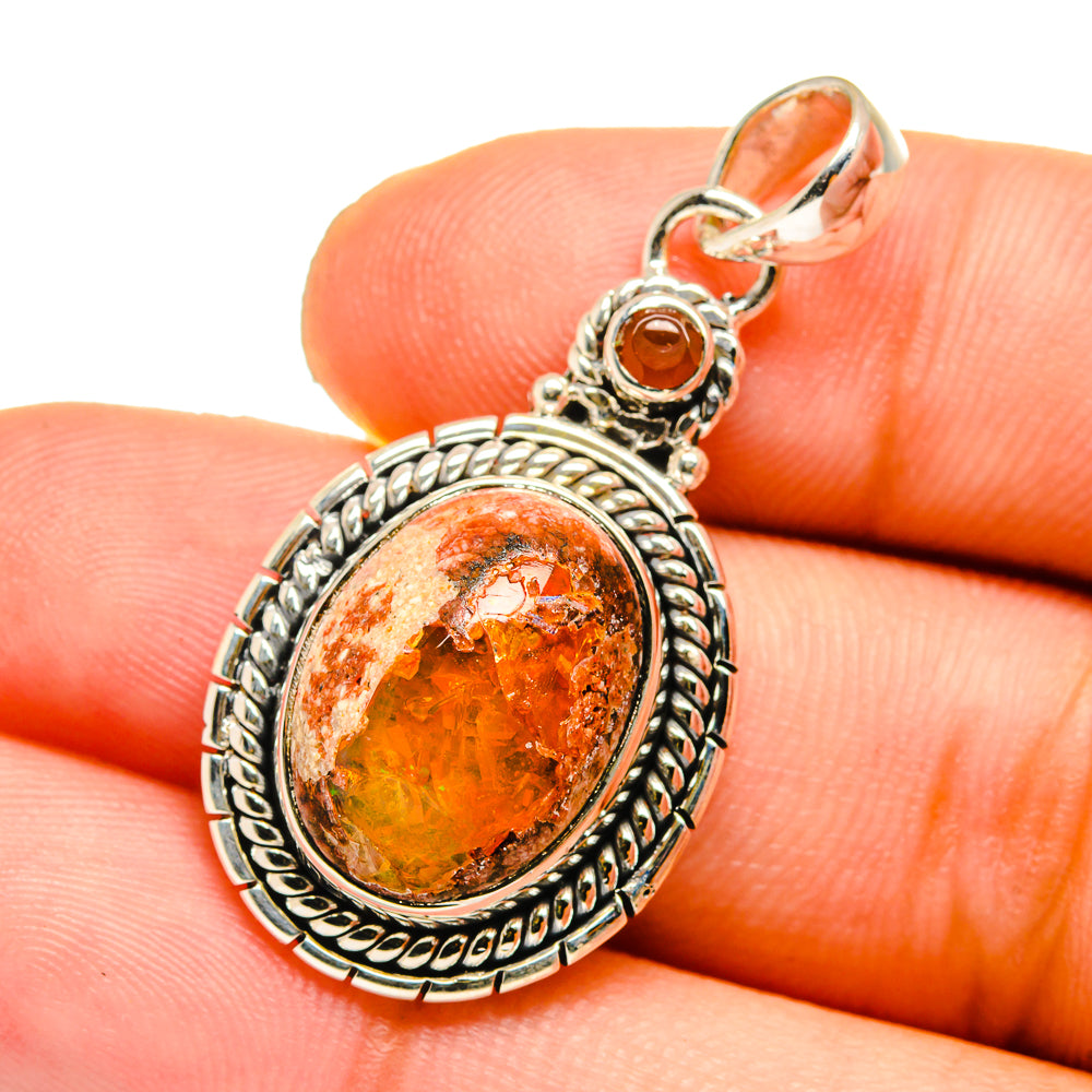 Oval orange fire opal pendant on 925 sterling silver with textured bezel and bail