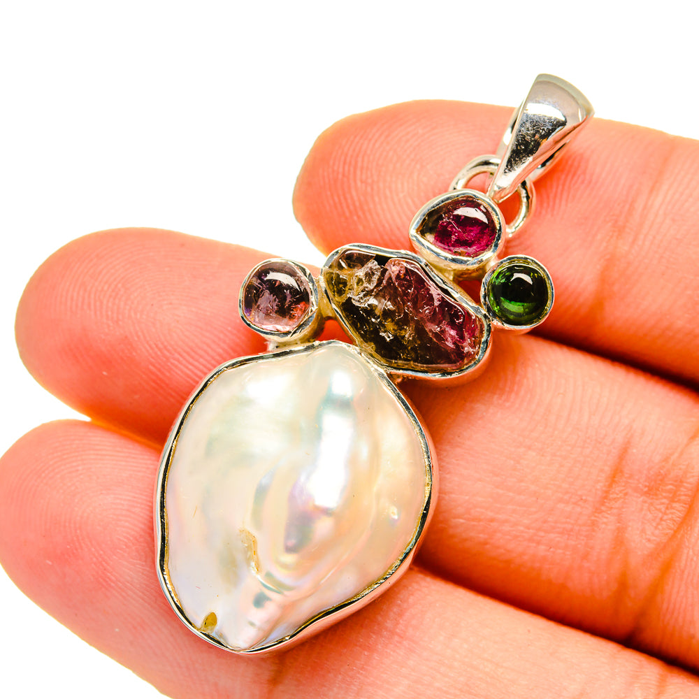Teardrop mother-of-pearl pendant with pink and green tourmaline accents on silver bail