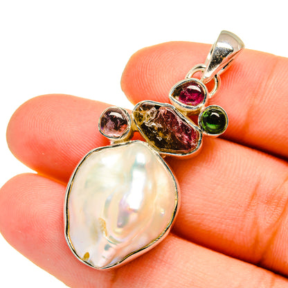 Teardrop mother-of-pearl pendant with pink and green tourmaline accents on silver bail