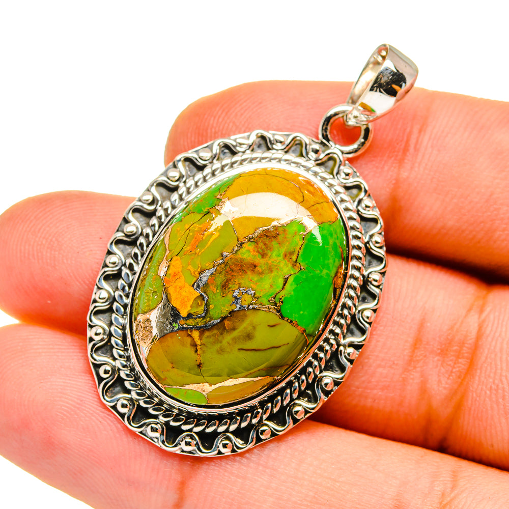 Green copper composite stone pendant with oval setting and silver-tone bail