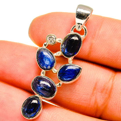 Blue oval stone pendant cluster in silver bezel with polished bail