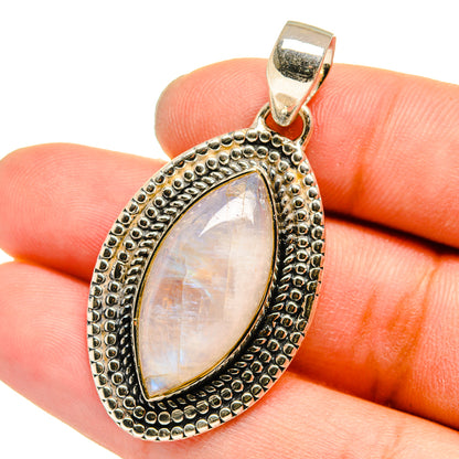 Moonstone pendant on finger, teardrop cabochon in silver-tone beaded bezel