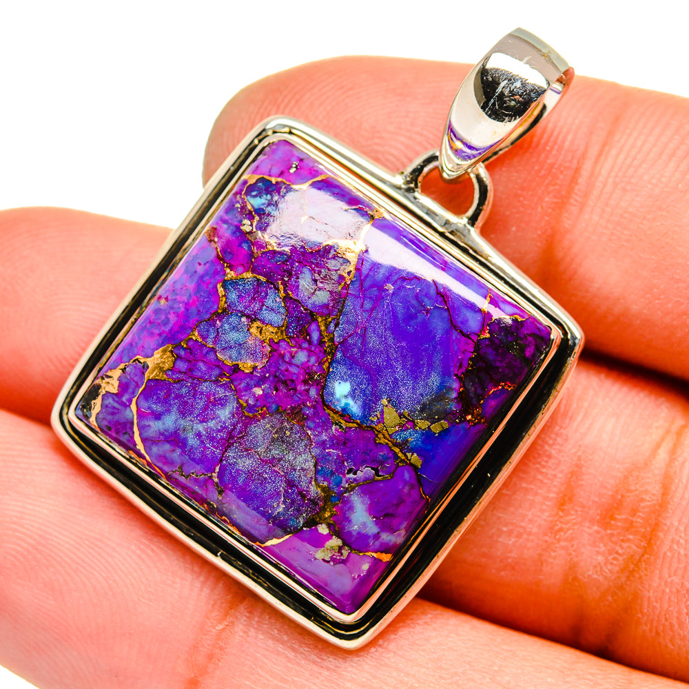 Purple composite turquoise pendant on square frame, silver bail; shown on hand