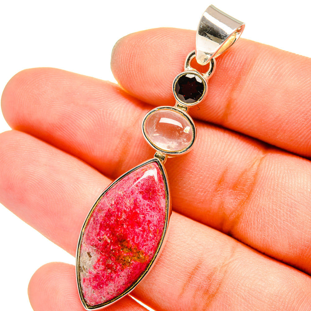 Gemstone pendant with red teardrop stone, round dark red and clear accents, silver-toned