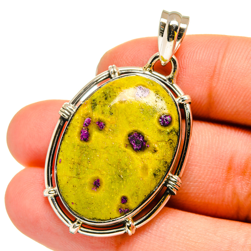 Oval yellow and purple-speckled atlantisite stone pendant in sterling silver frame