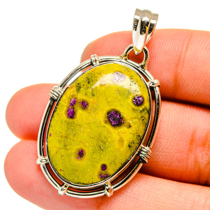 Oval yellow and purple-speckled atlantisite stone pendant in sterling silver frame