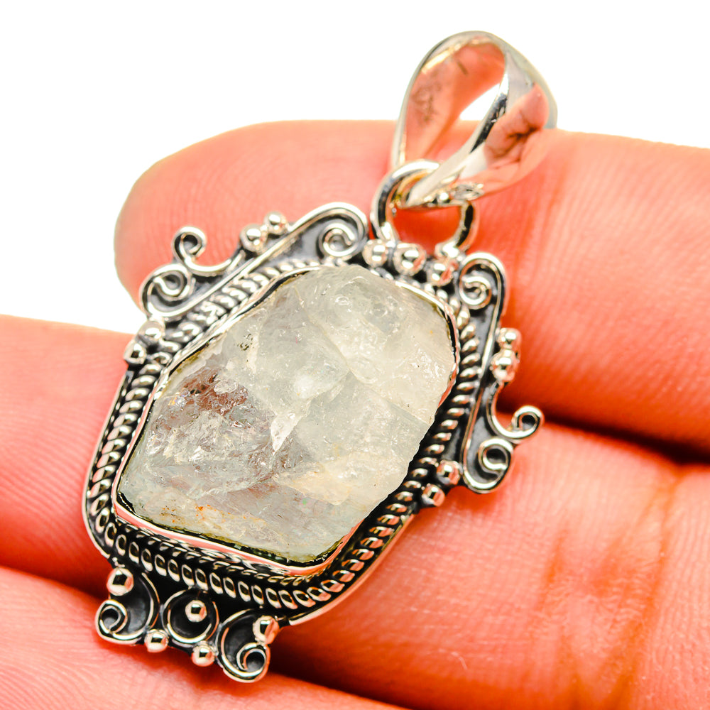 Sterling silver rough oval pale blue gemstone pendant in ornate filigree with top bail