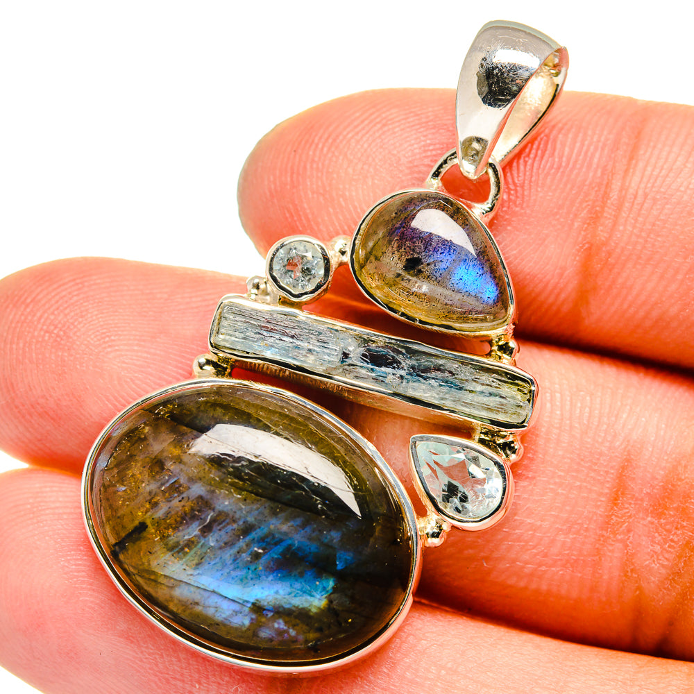 Sterling silver pendant with oval labradorite, blue flash accents and round topaz stones