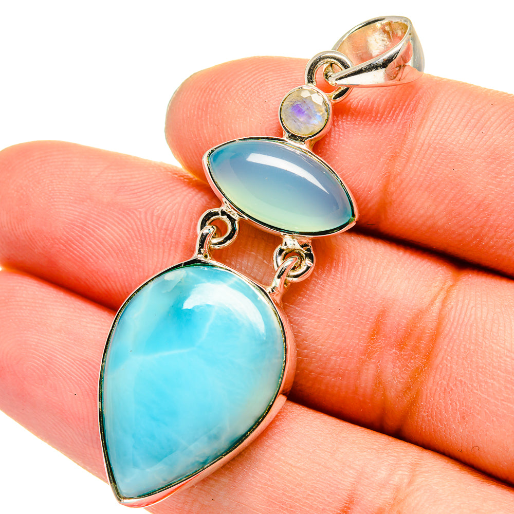Sterling silver pendant with blue oval stones and small iridescent round gem