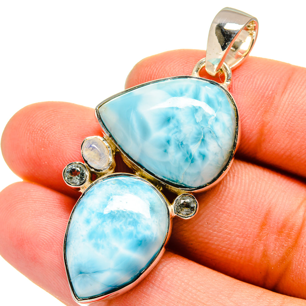 Sterling silver pendant with two sky-blue teardrop stones and small round clear accents