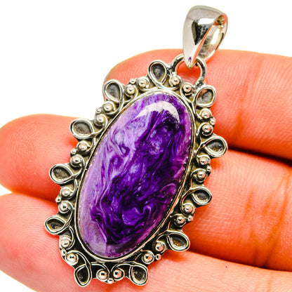 Oval charoite pendant with purple cabochon in ornate 925 sterling silver frame
