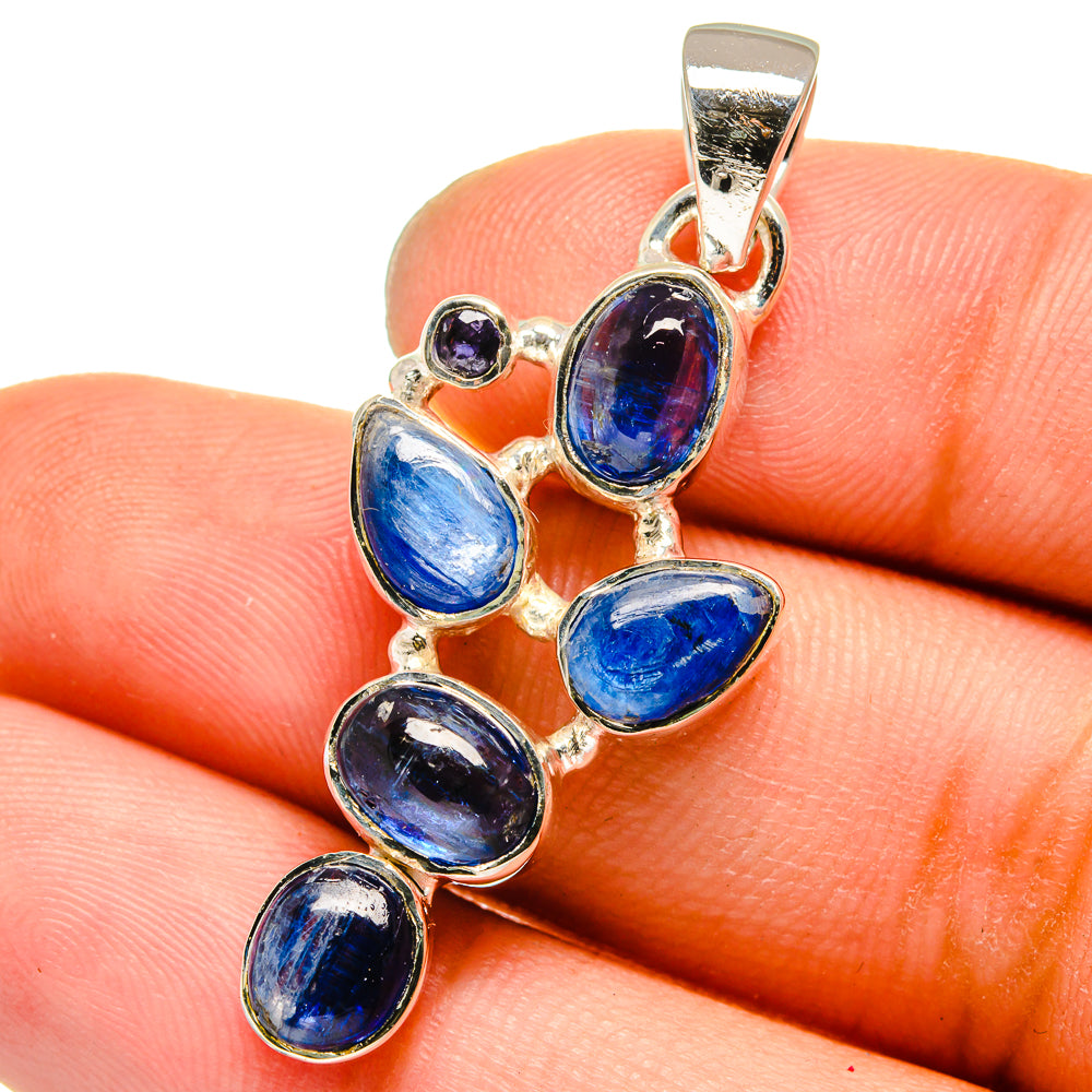 Sterling silver pendant close-up with oval blue stones and tiny purple stone