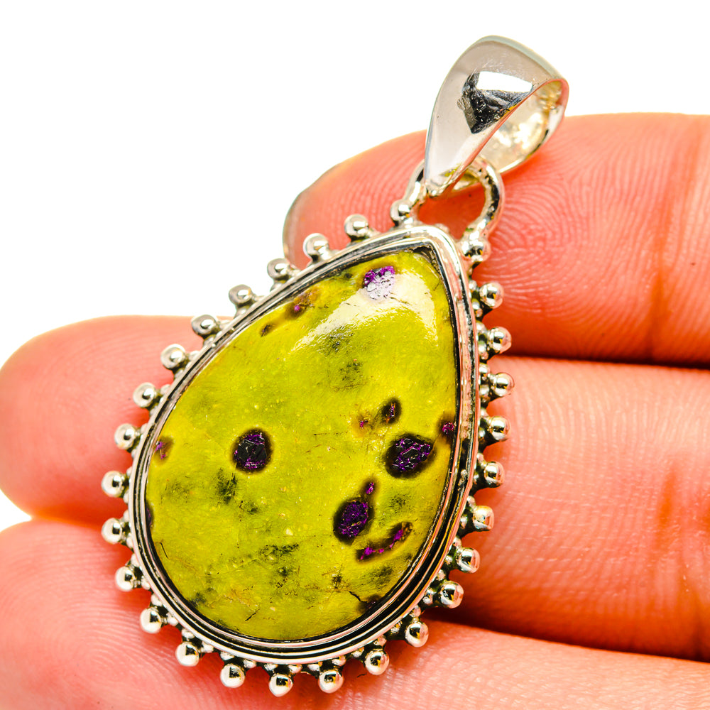 Sterling silver teardrop pendant with yellow-green gemstone and purple speckles, bead border