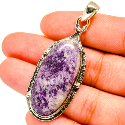Oval purple Tiffany stone pendant in 925 sterling silver bezel with bail, on hand