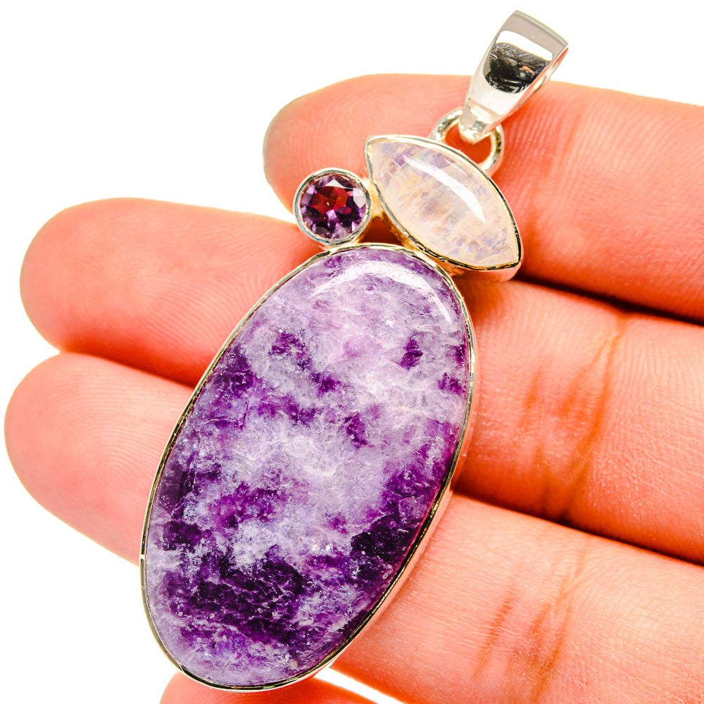 Sterling silver pendant with large oval purple gemstone, pale opal center, and small amethyst