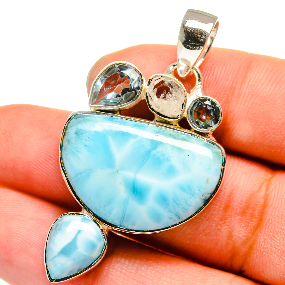 Sterling silver pendant with blue larimar teardrop and round accents, bail at top