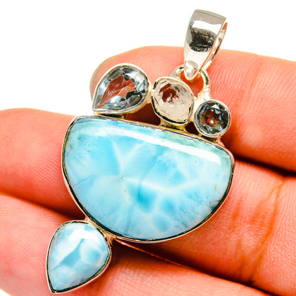 Sterling silver pendant with blue larimar teardrop and round accents, bail at top