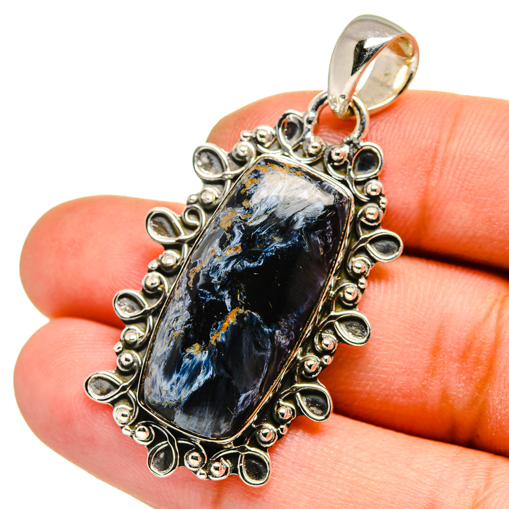 Pietersite pendant in 925 sterling silver bezel with ornate border, teardrop blue stone.