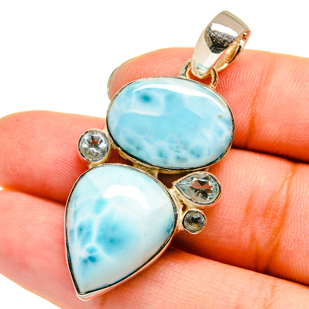 Sterling silver pendant with oval blue gemstone and teardrop blue stone, round accents