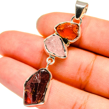 Sterling silver pendant with rough orange, pink, and dark red gemstone hearts