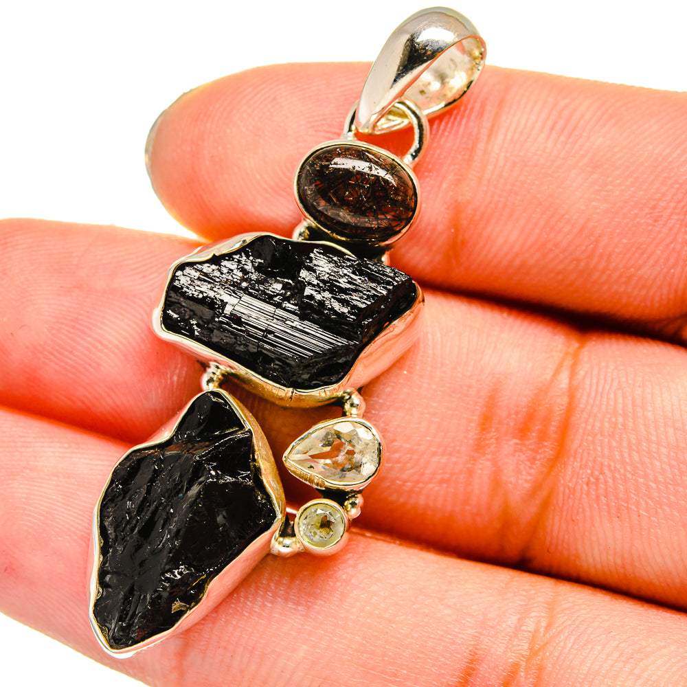 925 sterling silver pendant with rough black stones and small bezel-set clear gems