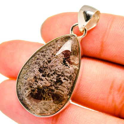 Teardrop garden quartz pendant with silver bezel and gold-tone bail, in hand