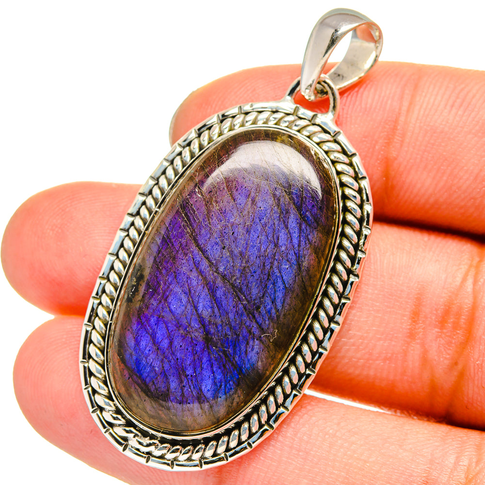 Sterling silver labradorite pendant with oval blue-purple stone and rope bezel