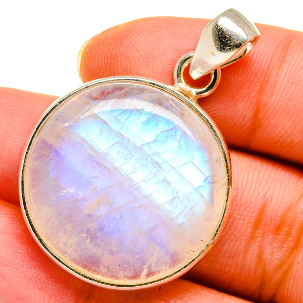 Opalescent moonstone pendant close-up with gold-tone bezel and loop bail